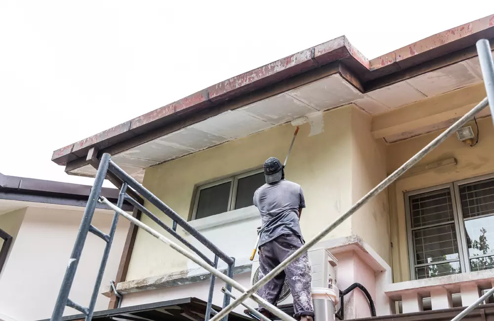 Professional villa painting services Dubai exterior painter working on house wall