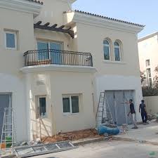 Skilled worker performing villa painting services Dubai exterior renovation